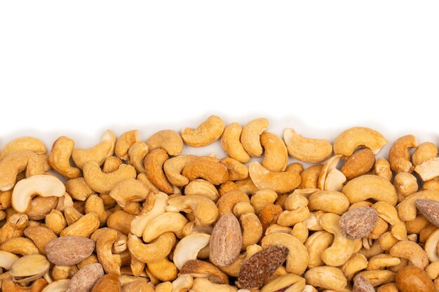 Mix of tasty salty nuts A group of almonds pistachios walnuts macadamia cashews