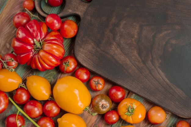 Mix tomatoes background. Several varieties of tomatoes on summer day. Different kind assorted colorful tomatoes.