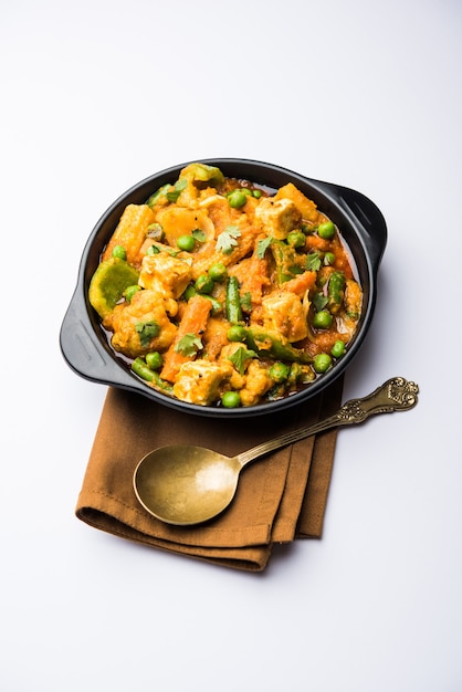 Mix vegetable curry - Indian main course recipe contains Carrots, cauliflower, green peas and beans, baby corn, capsicum and paneer or cottage cheese with traditional masala and curry