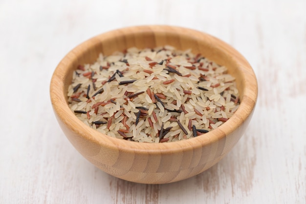 Mix of white, brown and black rice in bowl