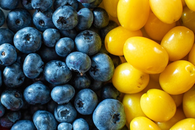 Photo mix of yellow and blue berries. summer mick fruit. berry layout