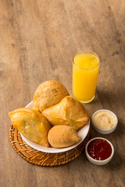 Mixed Brazilian deep fried chicken snack,, esfihas and pastry.