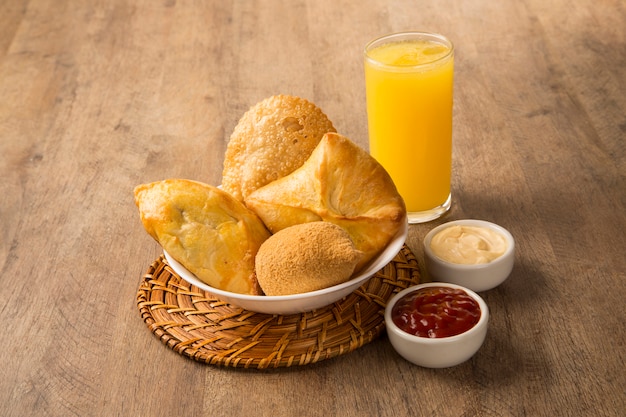 Mixed Brazilian deep fried chicken snack,, esfihas and pastry.