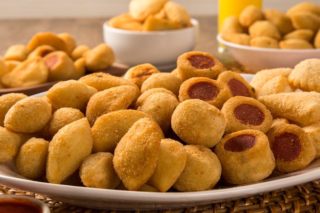 Mixed brazilian snacks fried on wooden background.