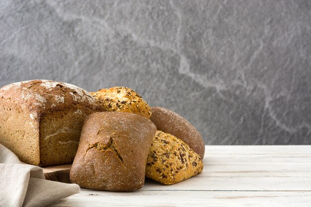 Mixed bread on white wooden table