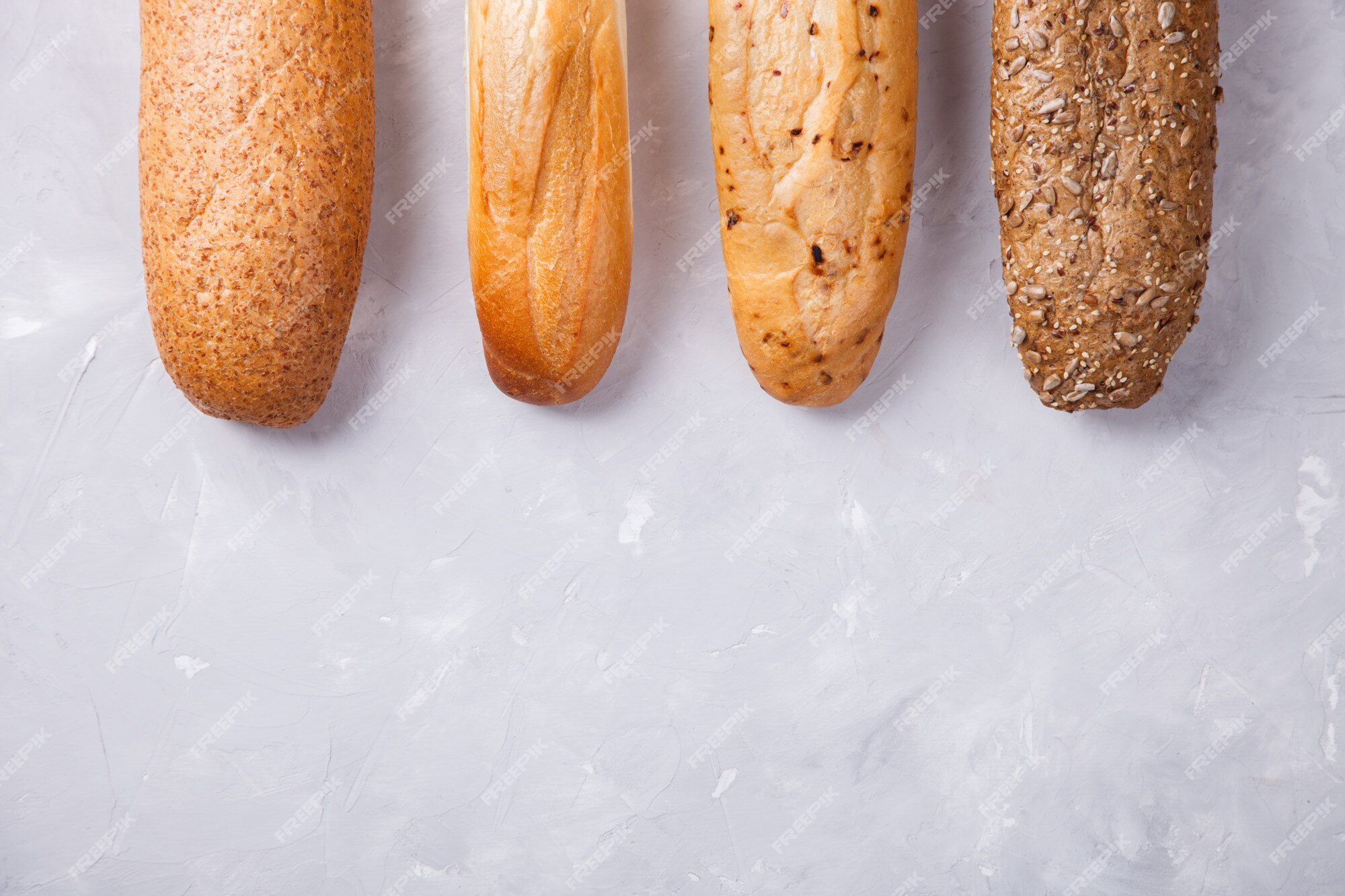 Premium Photo  Mixed breads on a light background,baguettes.top