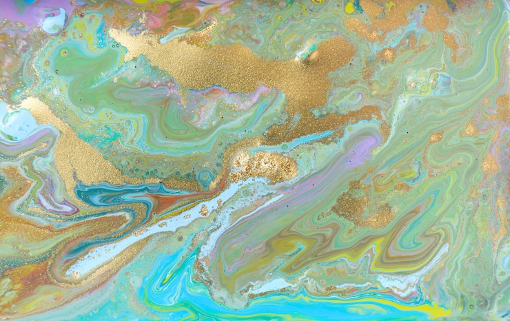 Photo mixed colored paints background. multicolor pattern with golden glitter.
