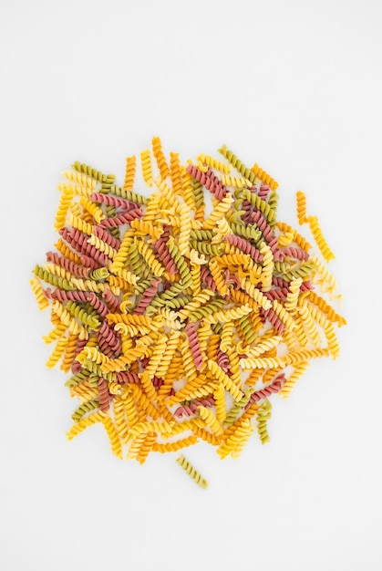 Mixed colorful pasta on white background