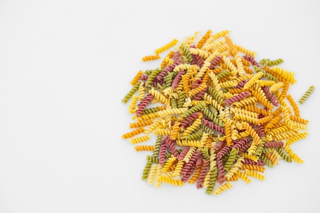 Mixed colorful pasta on white background