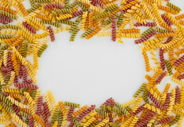 Mixed colorful pasta on white background