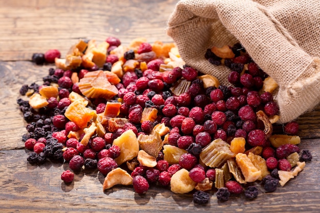 Mixed of dried fruits and berries on a wooden table