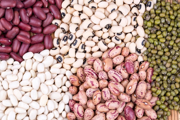 Mixed dried legumes and cereals isolated on white background, top view