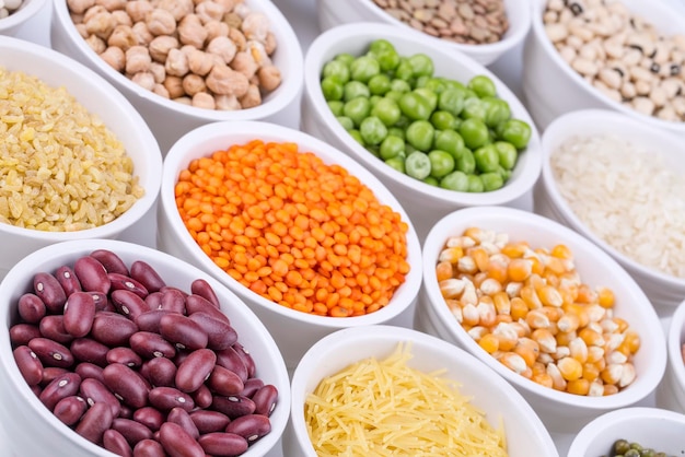 Mixed dried legumes and cereals isolated on white background, top view