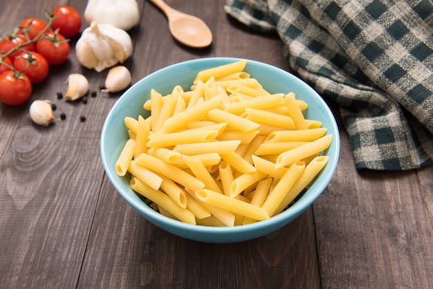 Mixed dried pasta selection on wooden table