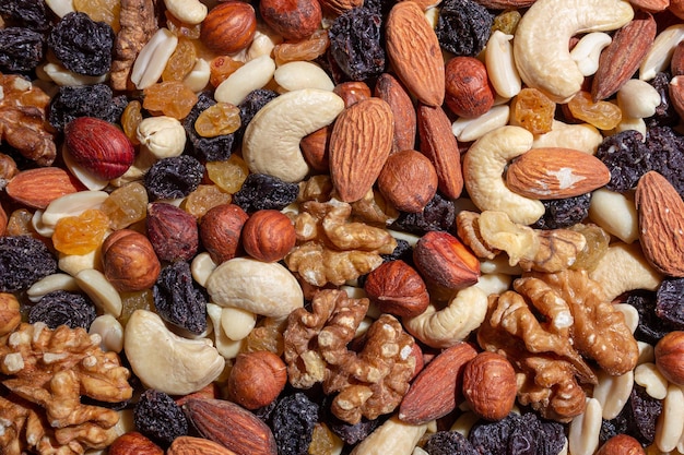 Photo mixed nuts almonds walnuts cashews peanuts hazelnuts dried prunes and raisins