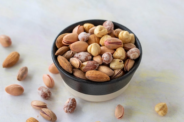 Mixed nuts in bowl on white background
