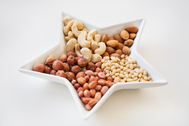 Mixed nuts in a dish in form of stars closeup