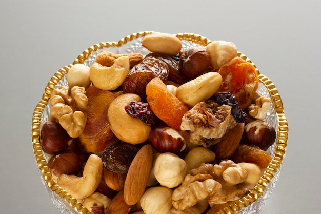 Mixed nuts in a glass plate Healthy and natural nutrition Cashew Almond Hazelnut Fig Walnut Apricot Raisin Blueberry