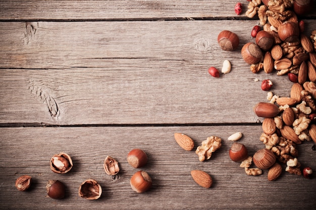 Mixed nuts on old wooden background