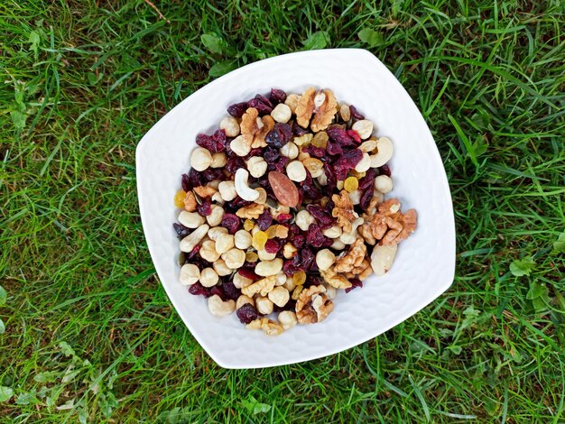 mixed nuts with raisins on a ceramic bowl image