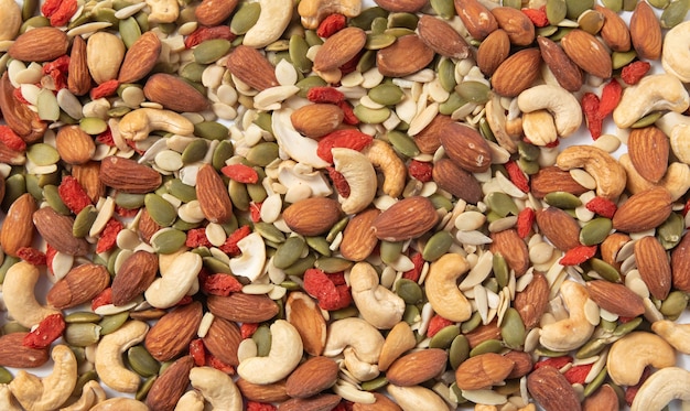 mixed organic cereal and grain seed pile on white background. 