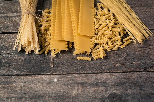 Mixed pasta . On a wooden background. Top view