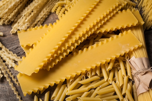 Mixed pasta . On a wooden background. Top view