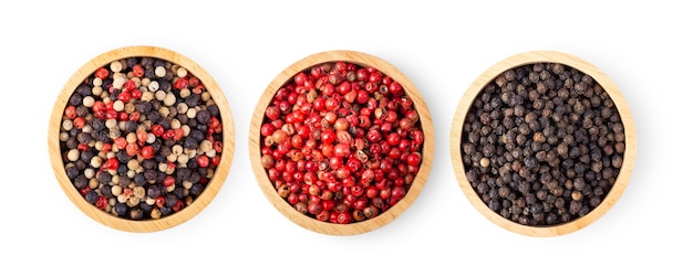 Mixed of peppers hot, red, black, white in wood bowl isolated on white background. Top view