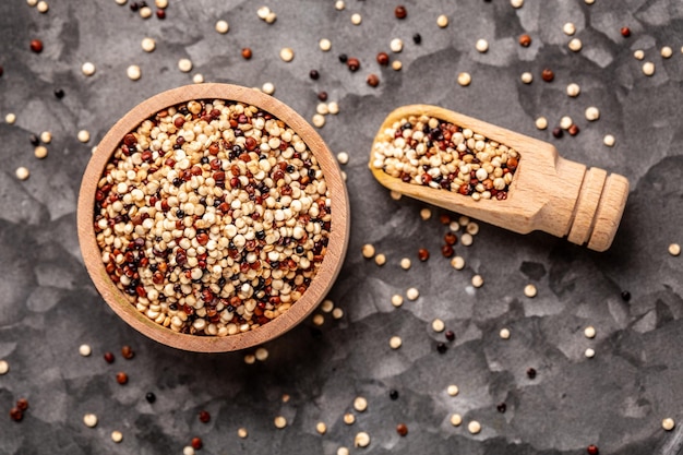 Mixed quinoa red white and brown quinoa in wooden bowl Healthy and gluten free food banner menu recipe place for text top view