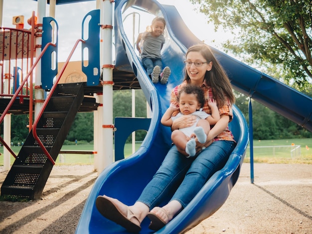 mixed race family having fun at the kids park
