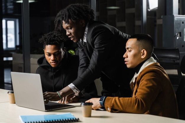 Mixed race of men teamwork on laptop in office Discussing and working on on online projects