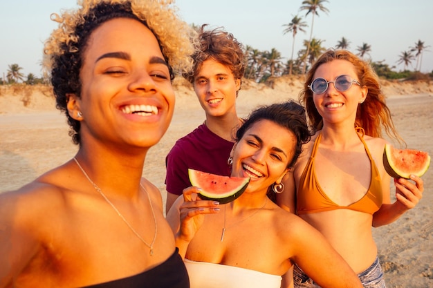 Mixed race people taking photos and video together on smartphone camera