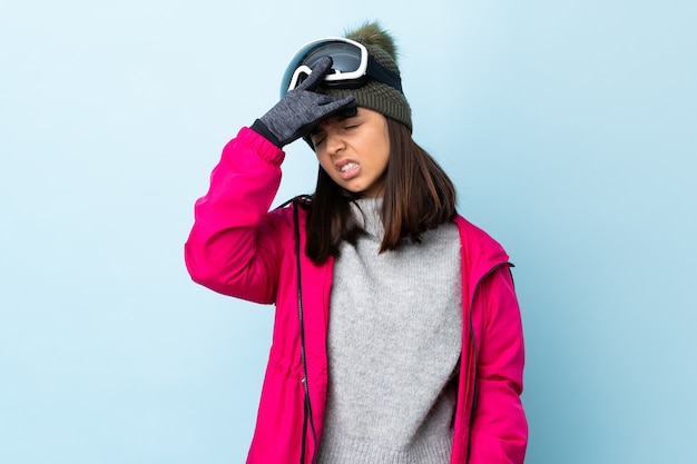 Mixed race skier girl with snowboarding glasses