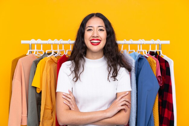 Mixed race woman in a clothing store laughing