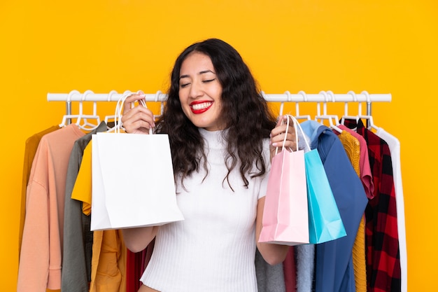 Mixed race woman in a clothing store and with shopping bags