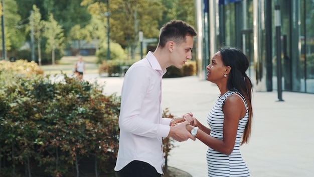 Mixed-race woman starts crying during the quarrel with her boyfriend in the street.