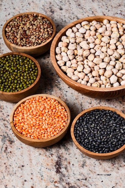 Mixed raw dried Indian seeds in wooden bowls