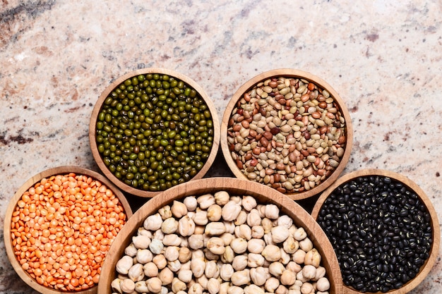 Mixed raw dried Indian seeds in wooden bowls