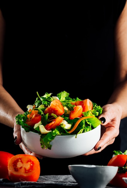 Mixed salad bowl with lettuce, tomato, arugula and mozzarella cheese