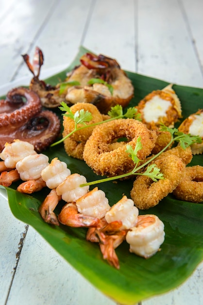 Mixed Seafood Baked With prawns squid octopus lobster and crab on banana leaf Brazilian gastronomy