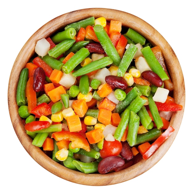 Mixed vegetables in wooden bowl isolated top view