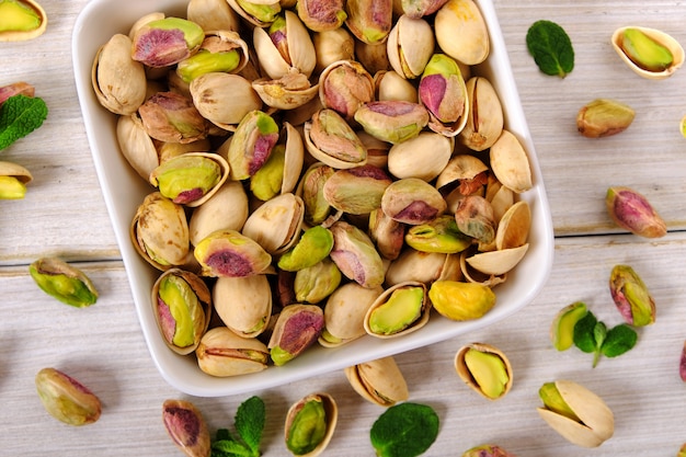 Mixed with peeled and unpeeled pitachio nuts close up