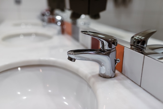 The mixer is mounted on a white sink.