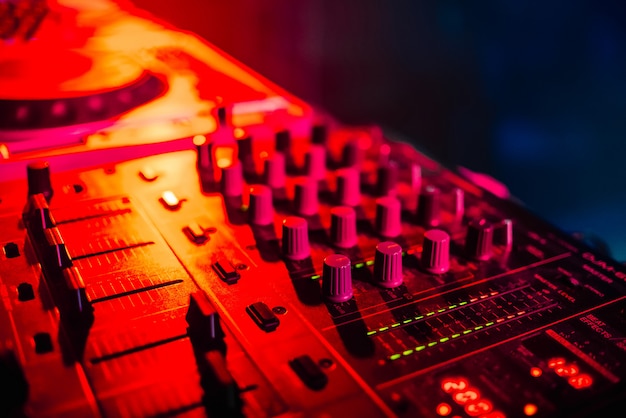 Mixer for music in the night club DJ closeup