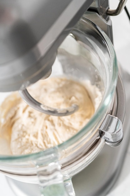 Mixing bread dough in a stand-alone kitchen mixer to bake patriotic cinnamon twists.