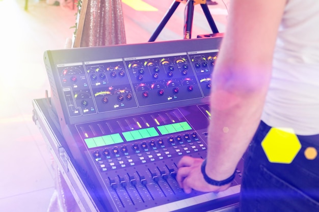 Mixing console at the party DJ holding hands and making music