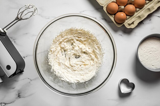 Mixing dough for heart shaped shortbread cookies for st valentine's day present Ingredients in the mixing bowl and a mixer Top view flat lay