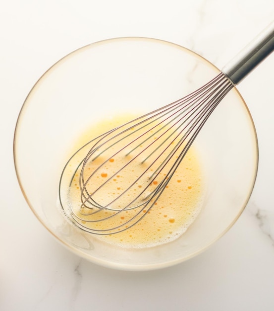 Mixing eggs in bowl on marble table homemade food recipe