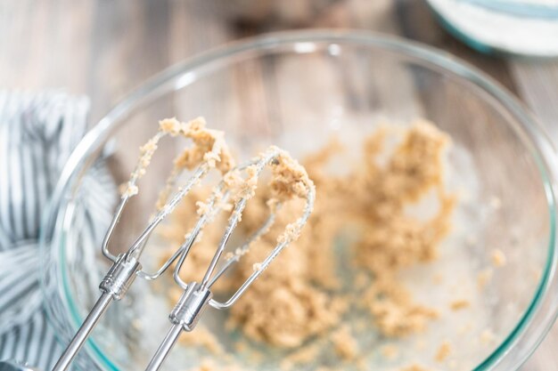 Mixing ingredients to bake chewy oatmeal raisin cookies.