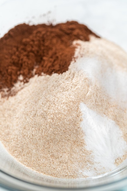 Photo mixing ingredients in a glass mixing bowl to bake chocolate graham crackers.